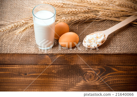 Cottage cheese, glass of milk, two eggs, wooden 21640066
