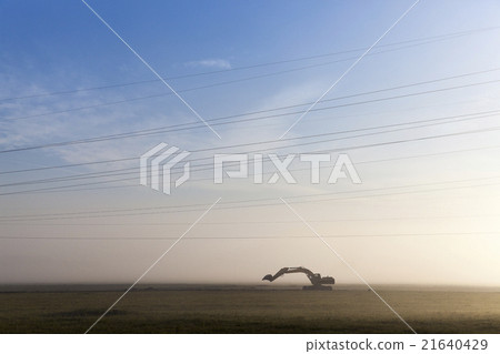 Excavator in a fog  21640429