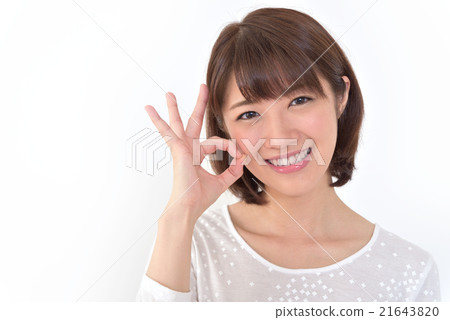 A smiley young woman giving an OK sign A smiley young woman giving an OK sign 21643820