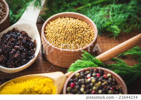 colorful spices in wooden spoons and bowls 21644234
