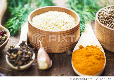 colorful spices in wooden spoons and bowls 21644236