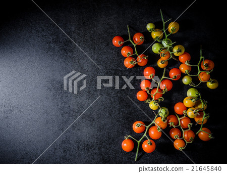 Fresh cherry tomatoes on black wooden background 21645840