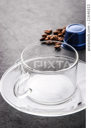 Glass cup with coffee capsule and coffee beans  21646815