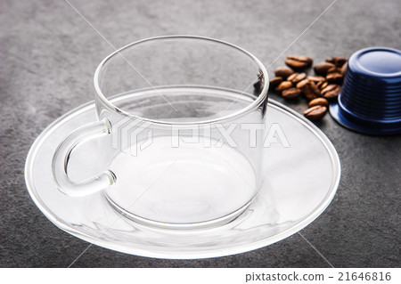 Glass cup with coffee capsule and coffee beans  21646816