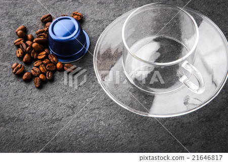 Glass cup with coffee capsule and coffee beans 21646817