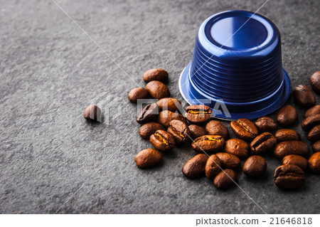 Coffee capsule and coffee beans  on the dark table 21646818