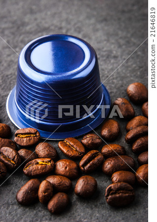 Coffee capsule and coffee beans  on the dark table 21646819