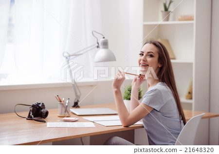 Positive girl sitting at the table 21648320
