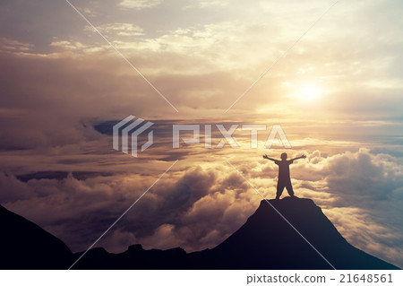 A boy standing on the top of the mountain A boy standing on the top of the mountain 21648561