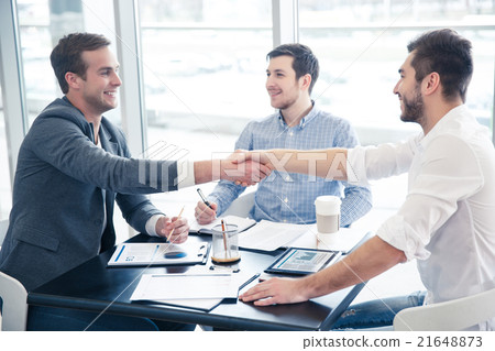 Cheerful colleague shaking hands Cheerful colleague shaking hands 21648873