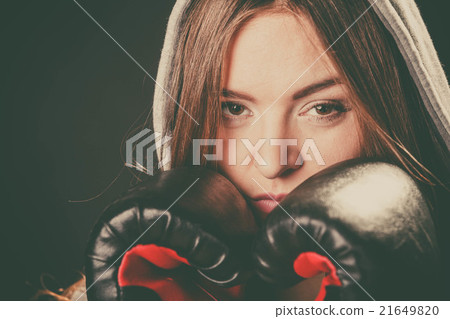 Woman cover face with boxing gloves. 21649820