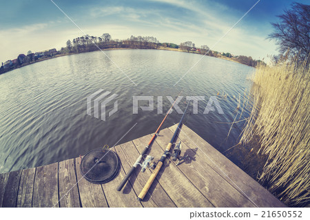 Vintage toned fisheye lens picture of fishing rods Vintage toned fisheye lens picture of fishing rods 21650552