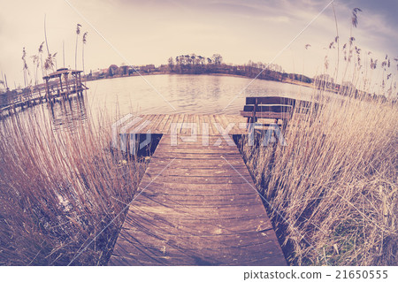 Vintage toned fisheye lens image of a wooden pier Vintage toned fisheye lens image of a wooden pier 21650555