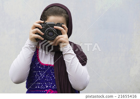 Young Little Girl Is Taking Photograph by Camera Young Little Girl Is Taking Photograph by Camera 21655416