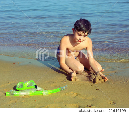 boy on the beach take sun bathing play with sand boy on the beach take sun bathing play with sand 21656199