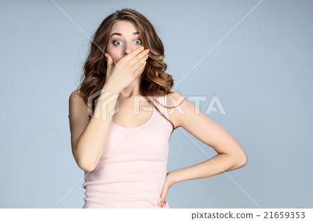 Portrait of young woman with shocked facial 21659353