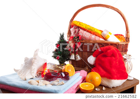 Christmas and beach accessories with basket over white 21662582