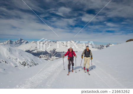 Two elderly men practice ski mountaineering 21663262