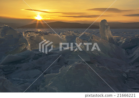 Transparent pieces of ice and the rising sun. Transparent pieces of ice and the rising sun. 21666221