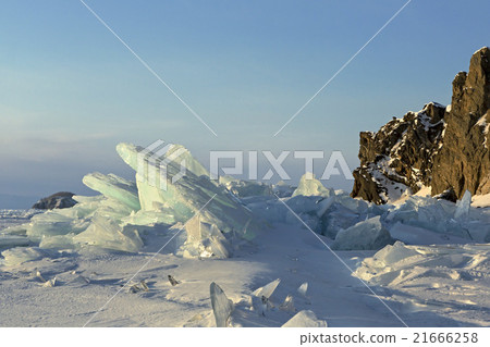 Clumps of blue ice on the snow. 21666258