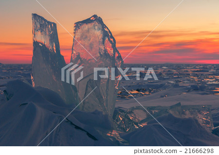 Transparent ice on sunset sky background. 21666298