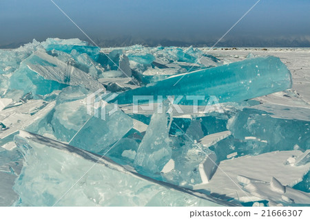 Clumps of blue ice on the snow. Clumps of blue ice on the snow. 21666307