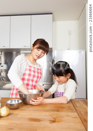 Mother and daughter cooking image 21666664