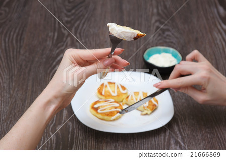 Girl eats cottage cheese pancakes 21666869