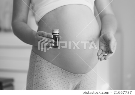 pregnant woman holding vitamins in pills pregnant woman holding vitamins in pills 21667787