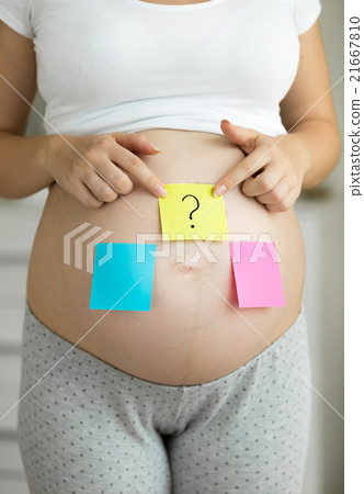 pregnant woman with pink and blue sticker on belly pregnant woman with pink and blue sticker on belly 21667810