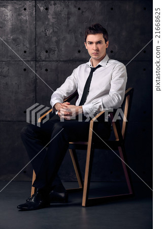 Portrait of successful businessman on a chair 21668625