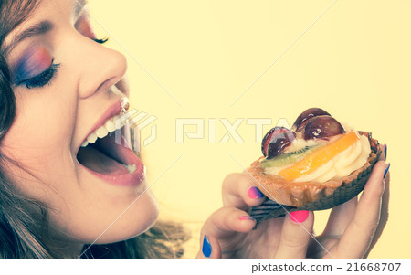 Closeup woman eating fruit cake sweet food 21668707