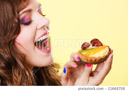 Closeup woman eating fruit cake sweet food Closeup woman eating fruit cake sweet food 21668708