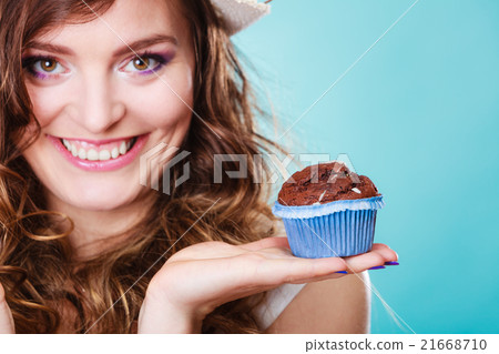Smiling woman holds chocolate cake in hand Smiling woman holds chocolate cake in hand 21668710