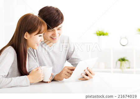 happy young Couple with tablet In living room happy young Couple with tablet In living room 21674019