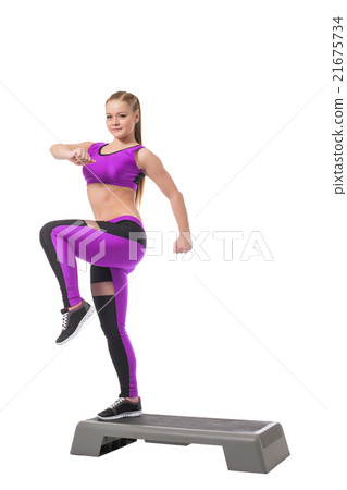 Lovely athletic girl training on stepper Lovely athletic girl training on stepper 21675734