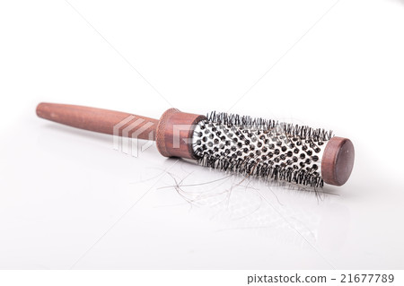 Comb with strand of hair on white background 21677789