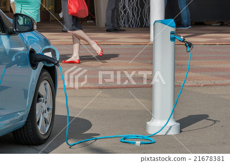 Charging an electric car Charging an electric car 21678381