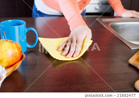 Attractive woman cleaning the counter in the kitchen 21682477