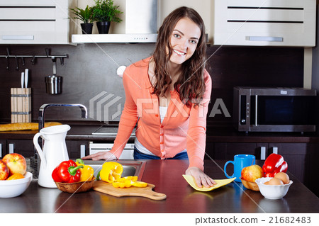 Attractive woman cleaning the counter in the kitchen 21682483
