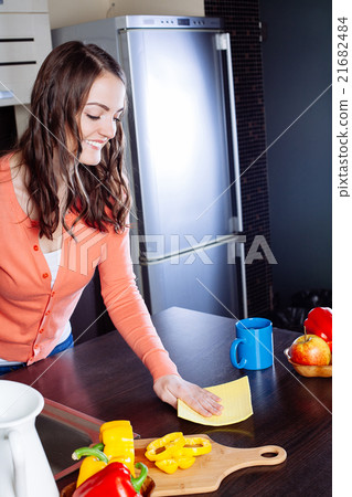 Attractive woman cleaning the counter in the kitchen 21682484