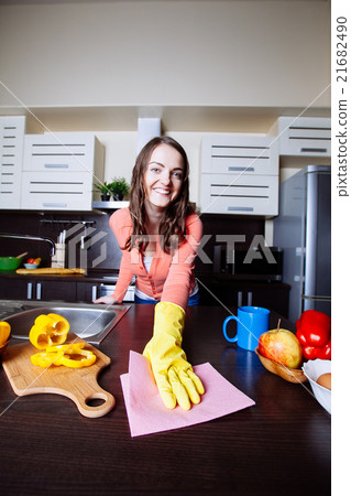 Attractive woman cleaning the counter in the kitchen 21682490