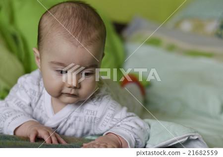 Baby girl with blue eyes learns to crawl 21682559
