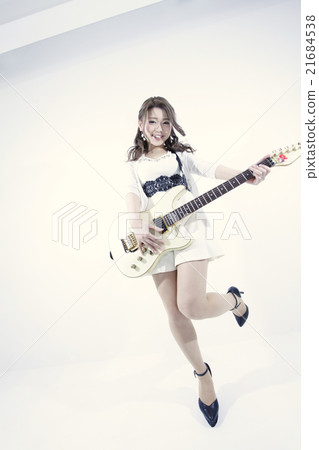 A woman playing an electric guitar 21684538