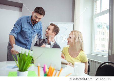 Cheerful creative team is discussing their work Cheerful creative team is discussing their work 21688970