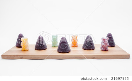 Cuberdons and sour bears on an plank Cuberdons and sour bears on an plank 21697555