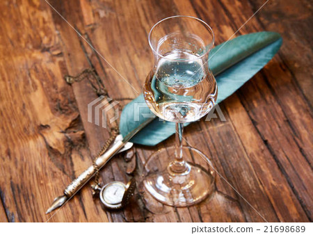 Grappa in a small glas on old wooden table Grappa in a small glas on old wooden table 21698689