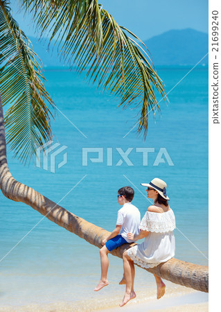 Mother and little son at tropical beach sitting on 21699240