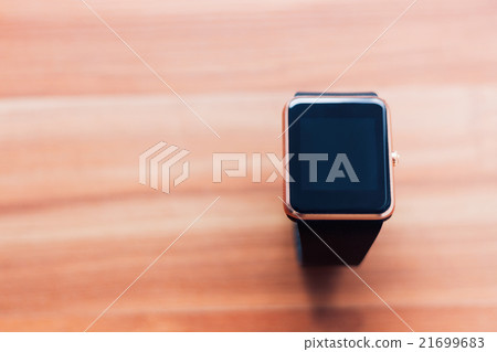Smart wrist watch on the wooden background Smart wrist watch on the wooden background 21699683