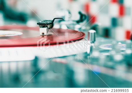 Turntable playing vinyl disc with music 21699935